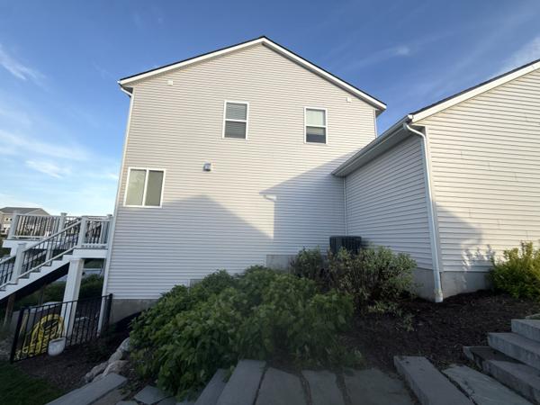 House siding soft washed clean of dirt, mold, and mildew in Grand Haven, Michigan
